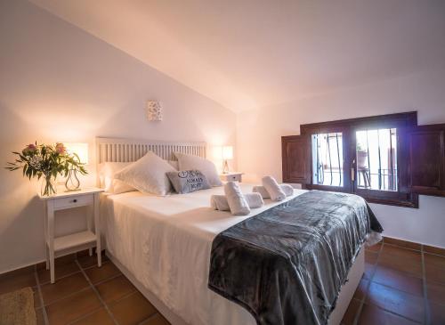 a bedroom with a large white bed with a window at Casa Carmen Altea with Terrace in Altea