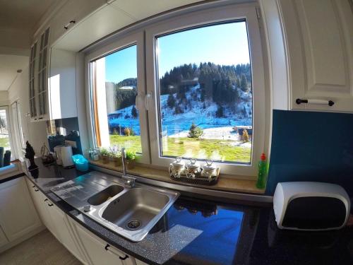 a kitchen with a sink and a window in an rv at Luxury Villa Kadic in Bjelašnica