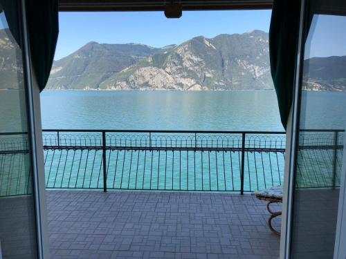 a view of the water from a balcony with a view at FIDES ON THE LAKE in Marone