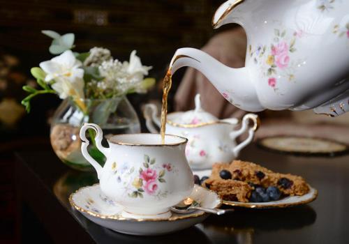 a teapot pouring tea into a cup on a table at The Villa Bridlington in Bridlington