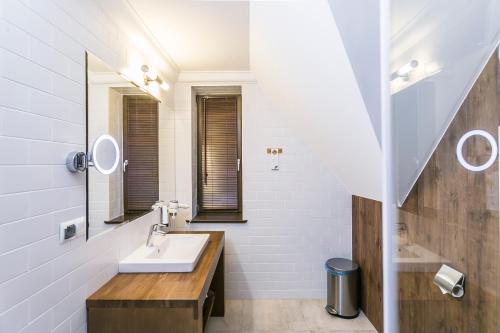 a bathroom with a sink and a mirror at Hotel Aubrecht Country Spa Resort in Przechlewo