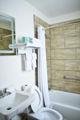 a bathroom with a toilet and a sink and a shower at Knights Inn Page in Page