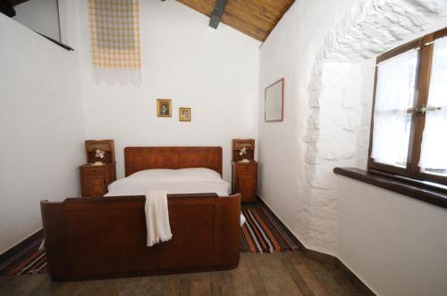 a bedroom with a bed and a window at Holiday Homes Poli Svetega Antona in Gračišće