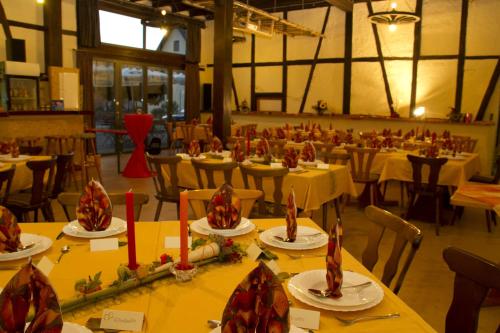 a banquet hall with tables and chairs with candles on them at Gasthaus zum Ochsen in Westernhausen
