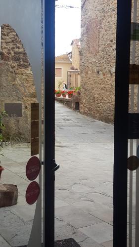 a glass door of a building with red signs on it at Locanda nel Cassero in Civitella Marittima