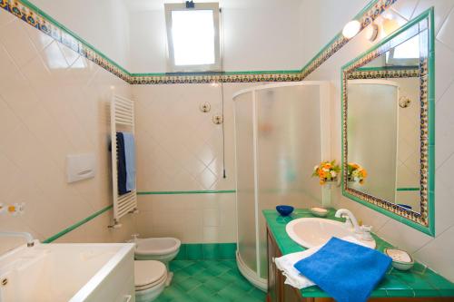 a bathroom with a sink and a shower and a toilet at Casa Marea in Conca dei Marini