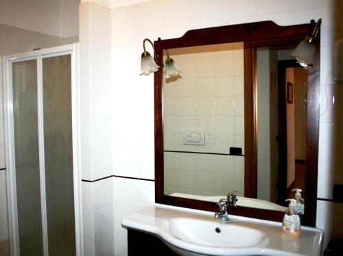 a bathroom with a sink and a mirror at Podere Olmo Adriano in Sovicille