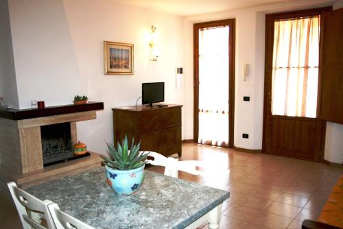 a living room with a table and a fireplace at Podere Olmo Adriano in Sovicille