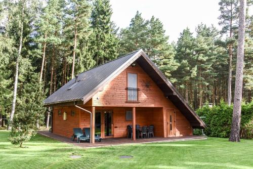 a log cabin with a gambrel roof at Vacation Home Mezsargi in Pape