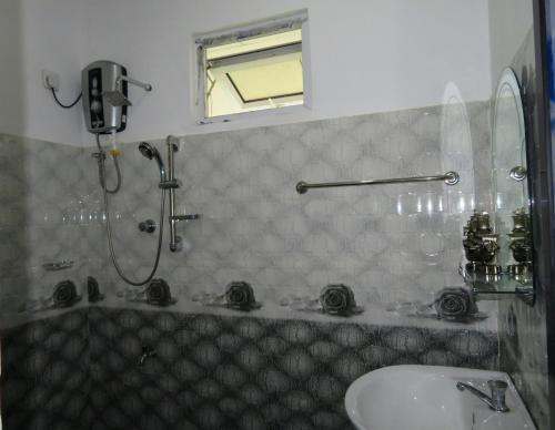 a bathroom with a shower and a sink at Stream View Family Resort in Dambulla