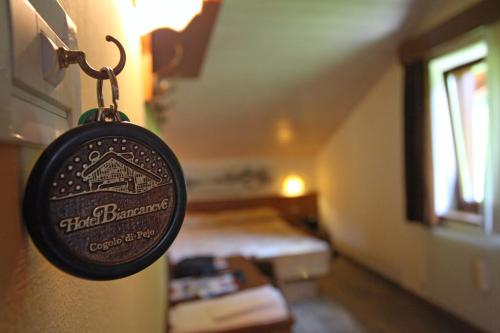 a sign hanging on a wall in a room at Hotel Biancaneve in Cogolo