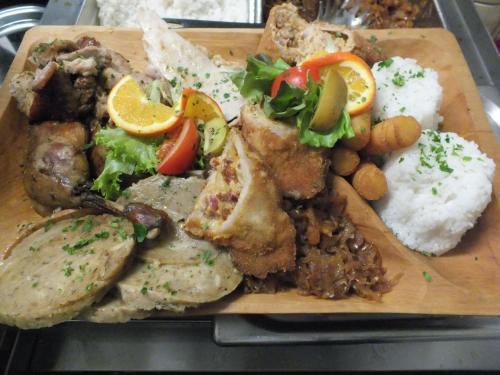 a plate of food with rice and meat and vegetables at Fehérló Vendégház & Restaurant in Bük
