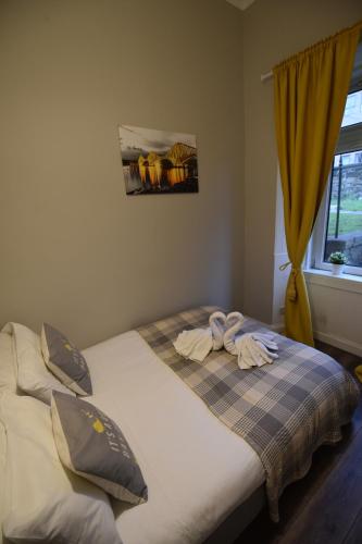 a bedroom with a bed with two towels on it at Slateford House Apartment Ground Floor Main Door in Edinburgh