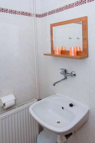 a white bathroom with a sink and a mirror at Penzion U Michala in Prášily