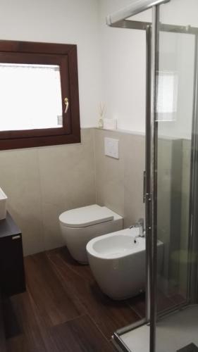 a bathroom with a toilet and a sink at Appartamento Modena Park in Modena
