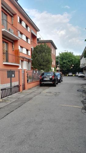 a car parked on a street next to a building at Appartamento Modena Park in Modena