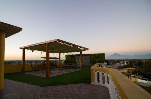 a rooftop deck with tables and a gazebo at Hotel Cacaxtla in La Concordia