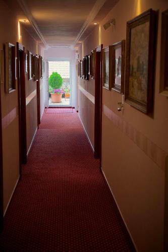 a long hallway with a red carpeted corridor at Haus Treffer in Kirchdorf in Tirol