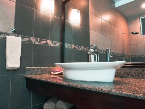 a bathroom with a white sink on a counter at Casa Caracol in Playa Coronado