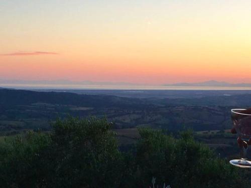 a view of the sunset from the top of a mountain at PODERE TORRICELLE 69B Pancole Gr, seaview infinity pool, jacuzzi, sauna, exclusive villa with 2 bedrooms for 4 - If you total 5 or 6 people there is an independent suite in main villa with private ensuite bathroom, kitchenette and garden dining area in Pancole