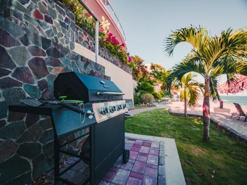 a blue grill sitting next to a stone wall at Casa Caracol in Playa Coronado