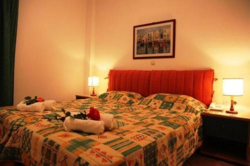 a hotel room with a bed with flowers on it at Terpsichore Apartments in Kyparissia