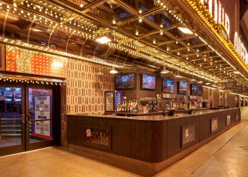 a bar in a room with many televisions at Four Queens Hotel and Casino in Las Vegas