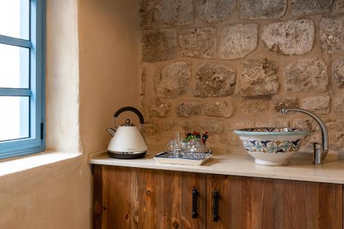 a kitchen counter with a sink and a tea kettle at Arabesque Arts & Residency in ‘Akko