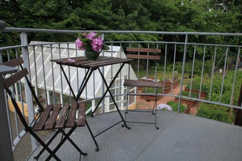 a table with a vase of flowers on a balcony at Bed & Breakfast Horsens in Horsens