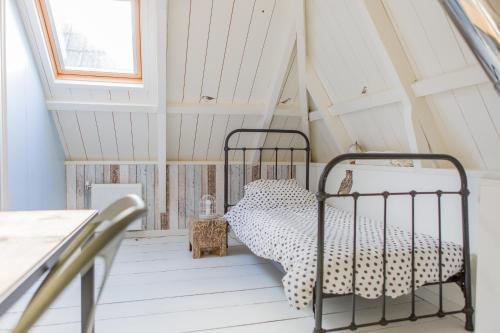 a bedroom with a bed in a attic at De Friese Wouden in Suameer