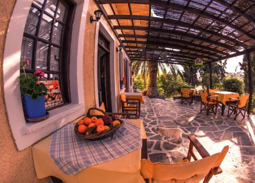 a table with a bowl of fruit on a patio at Vagia Traditional, Aegina Island in Vaia