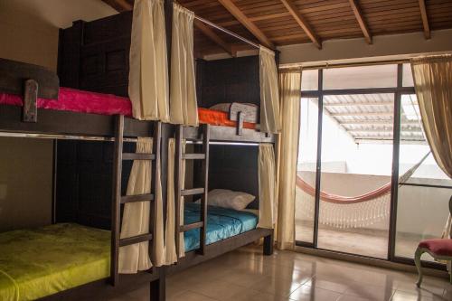 a room with two bunk beds with a window at Casa Azul Boutique Hostel in Pereira