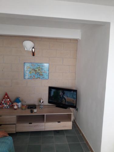 a living room with a flat screen tv on a wall at La Casa di Titina in Procida