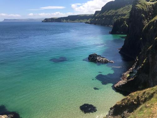 an aerial view of a body of water between two cliffs at Fairview House in Portstewart