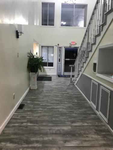 an empty hallway in a building with stairs at Days Inn by Wyndham Thomson in Thomson