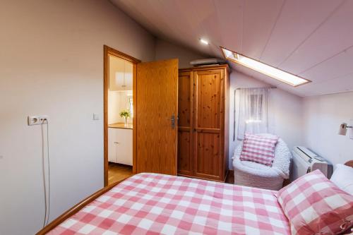 a bedroom with a bed with a checkered blanket at Bairro Alegre, Casa do Porto in Porto