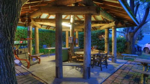 a wooden gazebo with a table and chairs at Yarram Holiday Park in Yarram