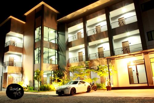 a car parked in front of a building at night at House 945 in Khon Kaen