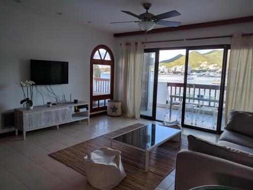 a living room with a couch and a tv at Simpson Bay Yatch Club 2 Bedrooms in Simpson Bay