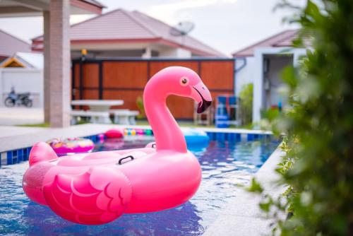 a pink inflatable pink swan in a swimming pool at Greenview Pool Villa Cha-am in Cha Am