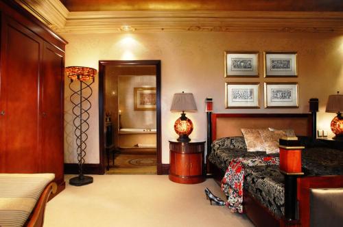 a bedroom with a bed and a bathroom at Peermont D'oreale Grande at Emperors Palace in Kempton Park