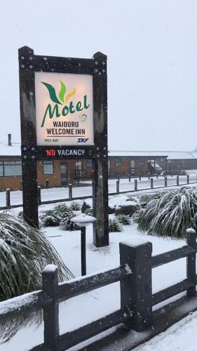 a sign for a motel in the snow at Waiouru Welcome Inn in Waiouru