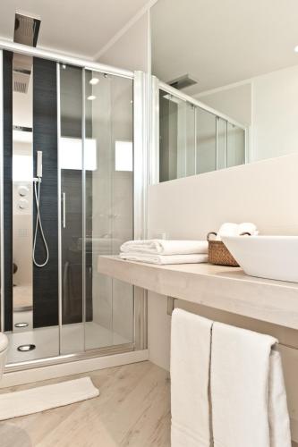 a bathroom with a shower and a sink at Hotel Torremaura in Milano Marittima