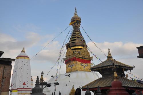 a building with a tower with a clock on it at STUPA VIEW INN in Kathmandu