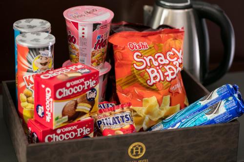 a box filled with different types of snacks and chips at Halais Hotel in Hanoi