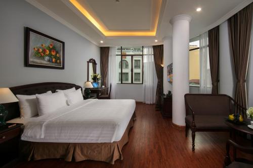 a hotel room with a bed and a chair at Halais Hotel in Hanoi