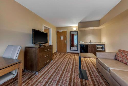 a living room with a couch and a flat screen tv at Comfort Inn South San Jose - Morgan Hill in Morgan Hill