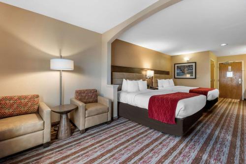 a hotel room with a bed and a chair at Comfort Inn South San Jose - Morgan Hill in Morgan Hill