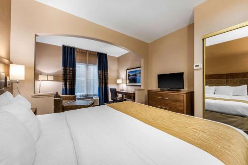 a hotel room with a bed and a television at Comfort Inn South San Jose - Morgan Hill in Morgan Hill