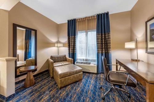 a hotel room with a desk and a chair at Comfort Inn South San Jose - Morgan Hill in Morgan Hill